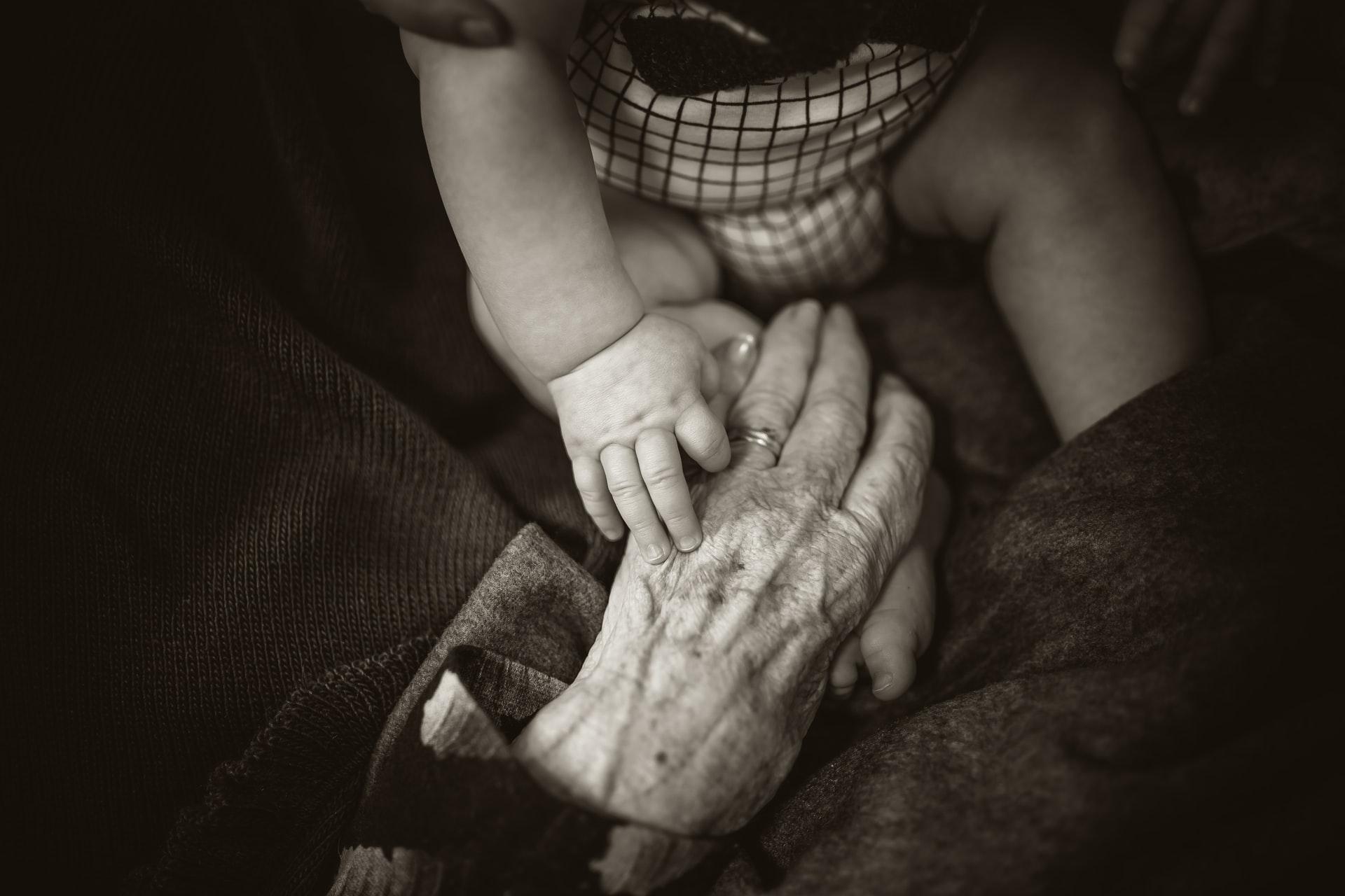 Young and old people holding hands